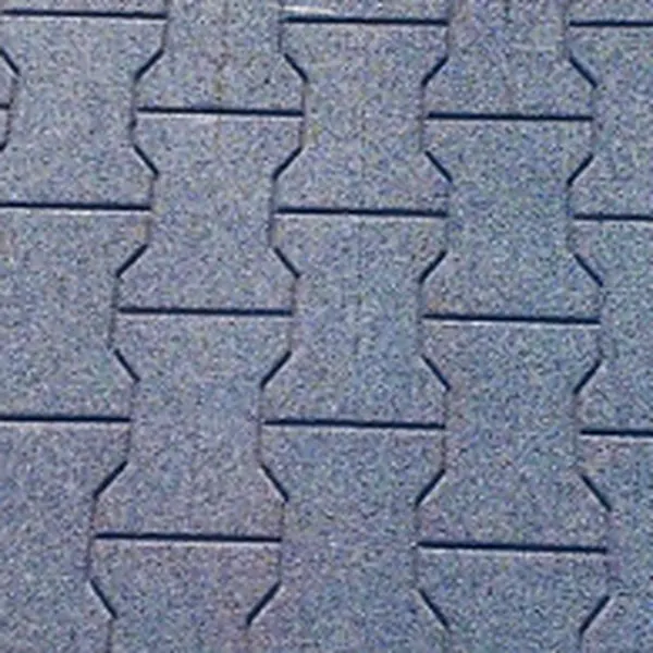 Legpatroon van grijze rubber staltegels in H-model, die als puzzelstukken in elkaar grijpen
